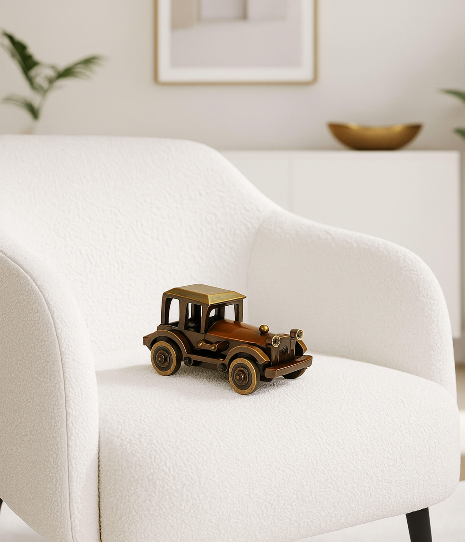 Small vintage-style toy car on a white armchair